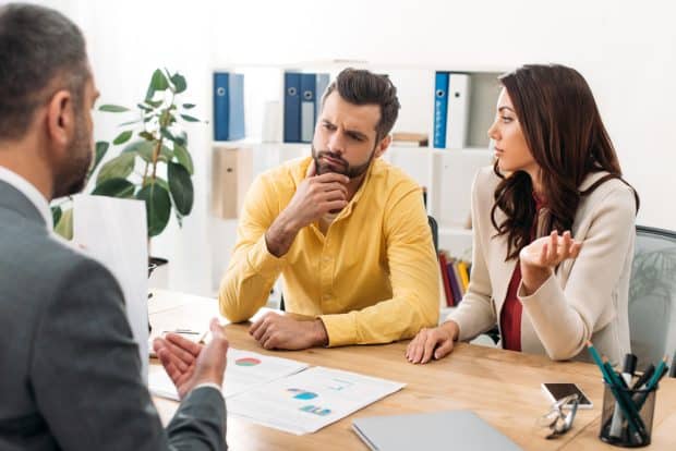 image of franchisees paying legal fees and sitting down with a franchise attorney