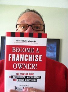 Joel Libava holding his top franchise buying book