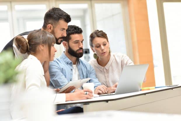 image of entrepreneurial college students with professor
