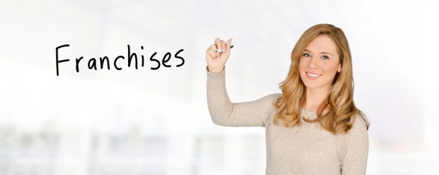 franchise consultant pointing to a franchising sign