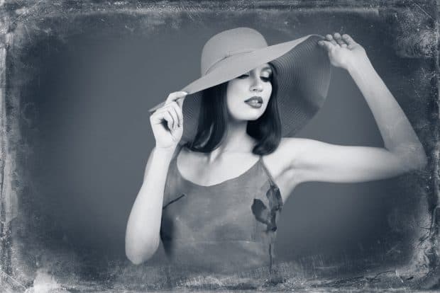woman holding hat