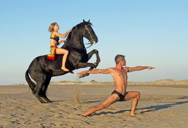 couple horseback riding on beach in north carolina