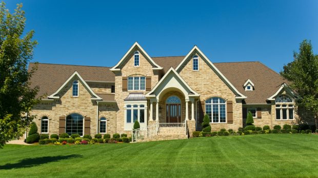 picture of large home with a great green lawn courtesy of a lawn care business